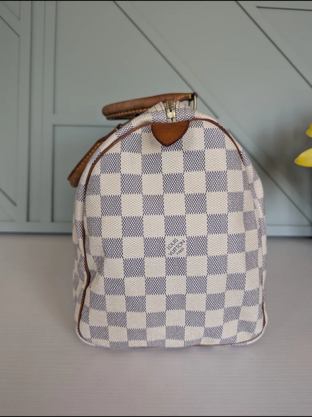Louis Vuitton Speedyhandbag styled in the iconic Damier Azur canvas pattern.